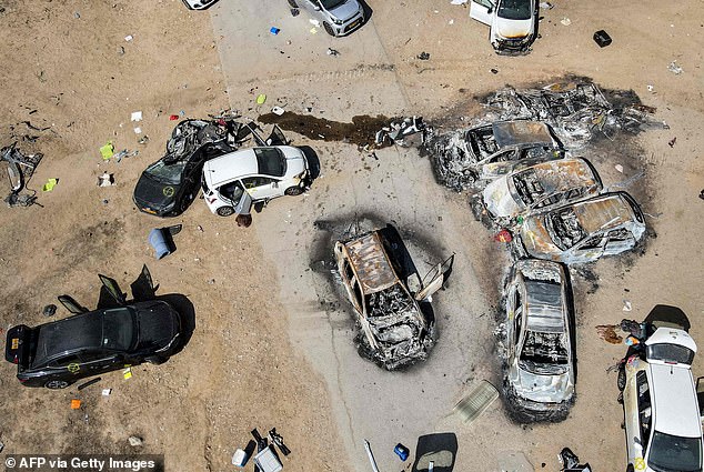 Aerial photo shows abandoned and torched vehicles at the site of the October 7 attack on the Supernova Desert Music Festival by Palestinian militants near Kibbutz Reim in the Negev Desert of southern Israel on October 13