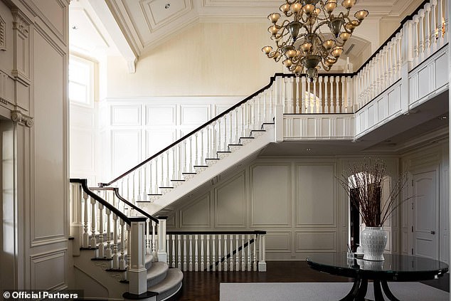 The grand foyer leads to a formal living room and gourmet chef's kitchen