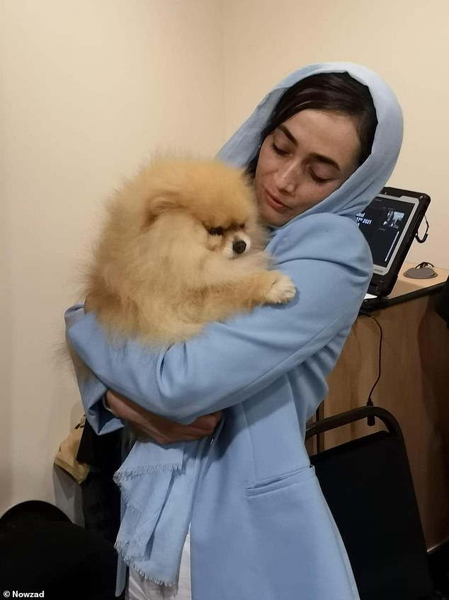 A woman hugs 'Ewok', the poster boy for animal welfare organization Nowzad, during a fundraising event