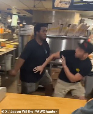 The man walks forward and knocks the employee to the ground