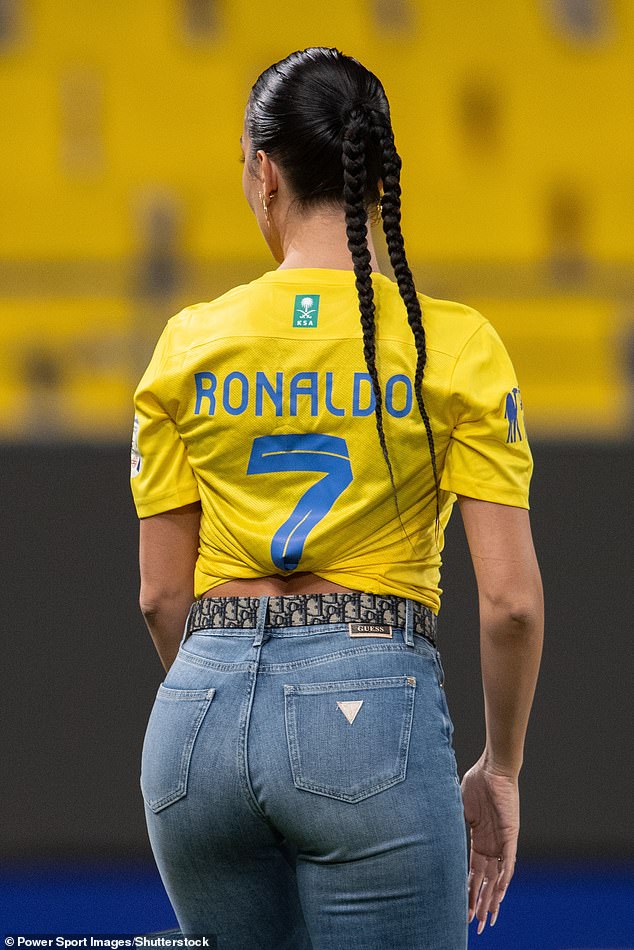 From behind: The influencer accessorized her look with a Dior belt and she swept back her raven braids into a sleek double-braid ponytail