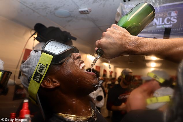 Geraldo Perdomo sips champagne after Tuesday's win over the Phillies