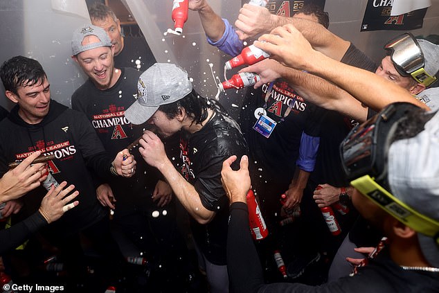 Diamondbacks rookie outfielder Corbin Carroll gets a Budweiser shower after the game