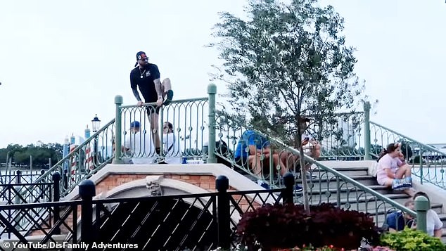 In the footage, the brave man teetered on the edge of Disney's bridge as bystanders encouraged him to take the plunge.  The jumper then launched himself into the 