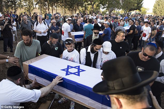 Mourners attend the funeral of members of the Sharabi family killed in the attack on Kibbutz Be'eri on October 25, 2023 in Kfar Harif, Israel