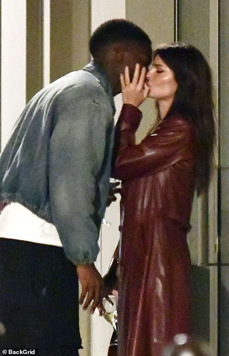 Kiss: The supermodel, 31, who has been dating Eric André, DJ Orazio Rispo and Harry Styles since splitting from husband Sebastian Bear-McClard last year, appeared smitten with the French star, 27, as they locked lips in the street