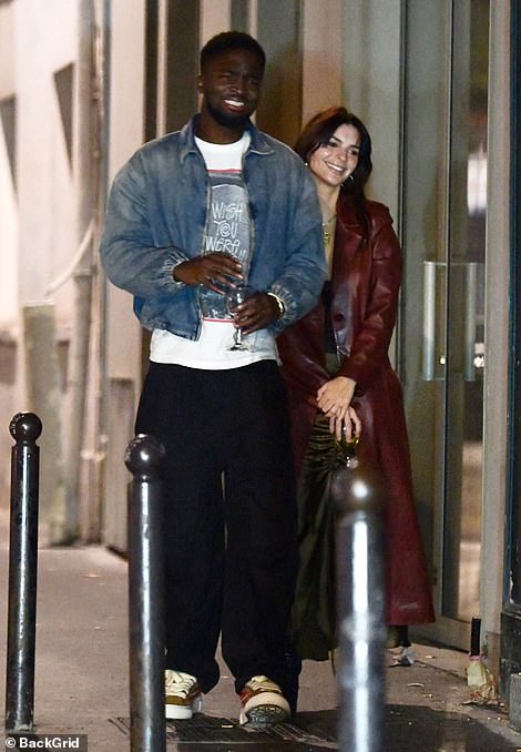 Cute couple: The couple looked happy as they strolled through France together during their date