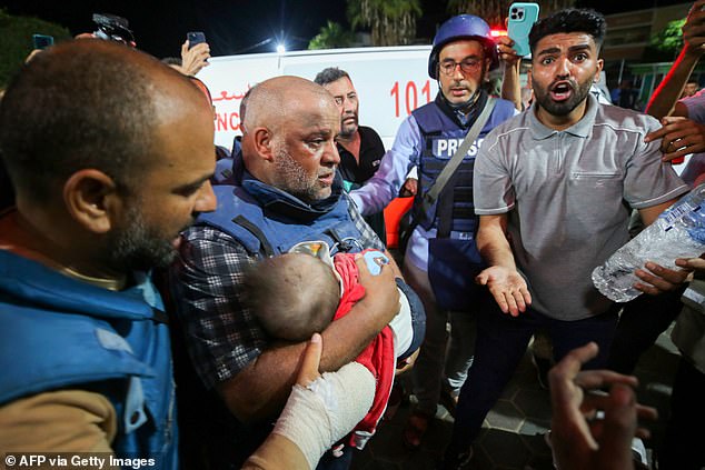 Al-Jazeera correspondent Wael Al-Dahdouh mourns the body of one of his children who was killed along with his wife and daughter during an Israeli attack in the Nuseirat camp, at Al-Aqsa Hospital in Deir Al- Balah in the southern Gaza Strip