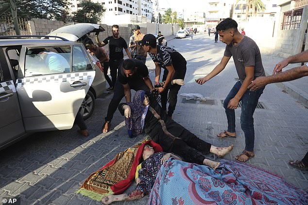 Palestinians transport injured women found on the streets after Israeli airstrikes on Gaza City