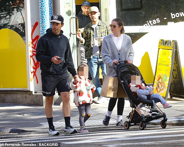 Casual cool: The musician opted for a casual look, with a black hoodie, black shorts and a matching baseball cap