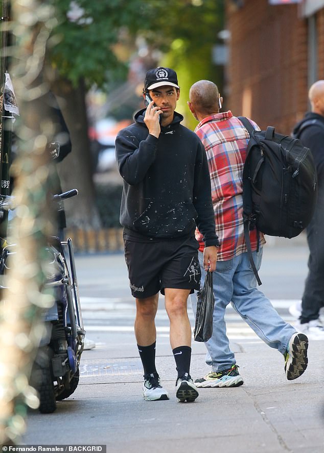 Relaxed: The Jonas Brothers member completed his outfit with a pair of white and gray sneakers