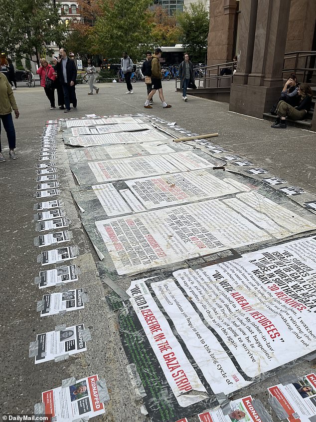 Posters calling for a ceasefire in the Gaza Strip lie on the ground, alongside posters calling for the release of the 200 hostages currently held by Hamas