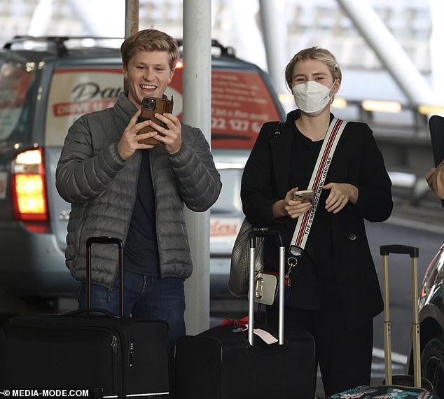 The lovebirds laughed and smiled for the cameras