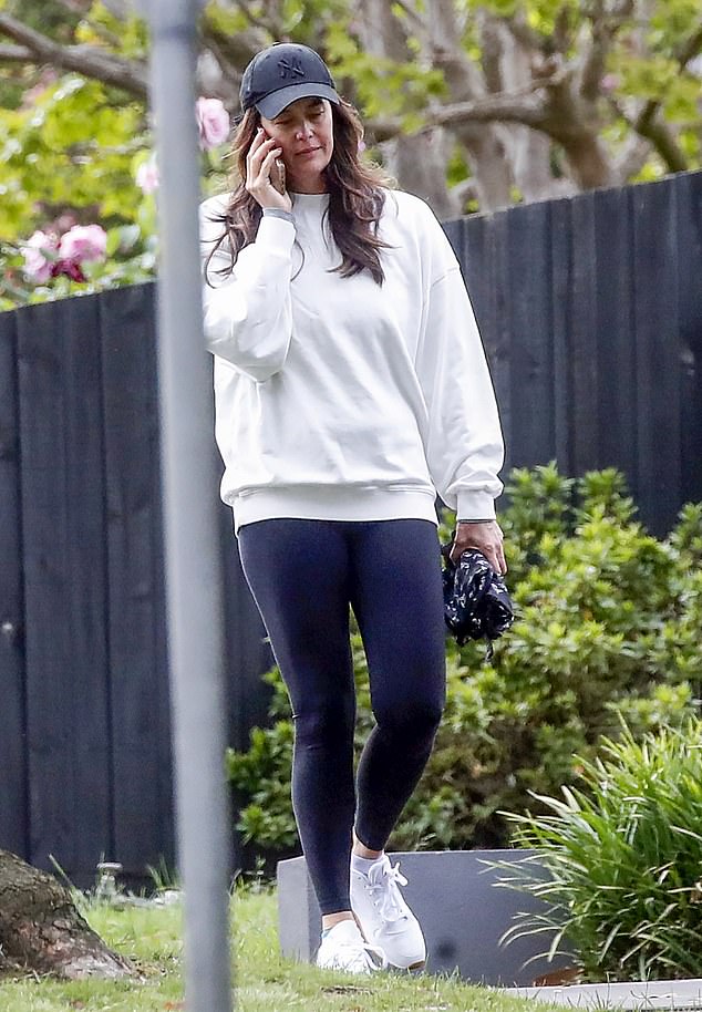 Megan kept it sporty in black sports leggings, a gray sweater and white comfortable sneakers