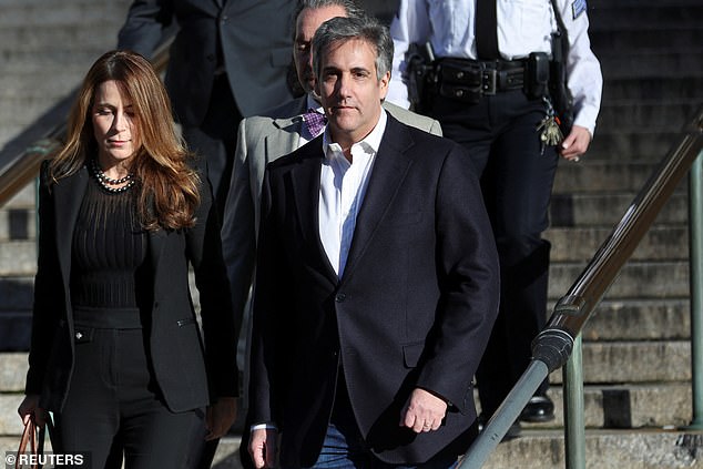 Michael Cohen walks outside the New York State Supreme Court after the trial was postponed for a day