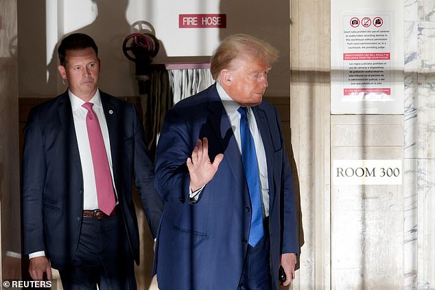 Trump gestures as he returns to the courtroom after a break in his civil fraud case at the New York Supreme Court.  He was fined $10,000 for violating the judge's silence order for the second time