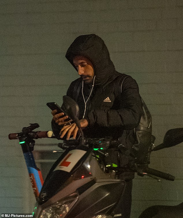 Outing: The professional dancer, 33, wrapped up in a padded jacket and track pants as he hopped on an e-scooter in London on Wednesday evening