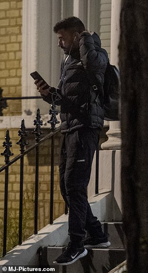 Dejected: Giovanni cut a solemn figure as he left a London apartment and hopped on a scooter