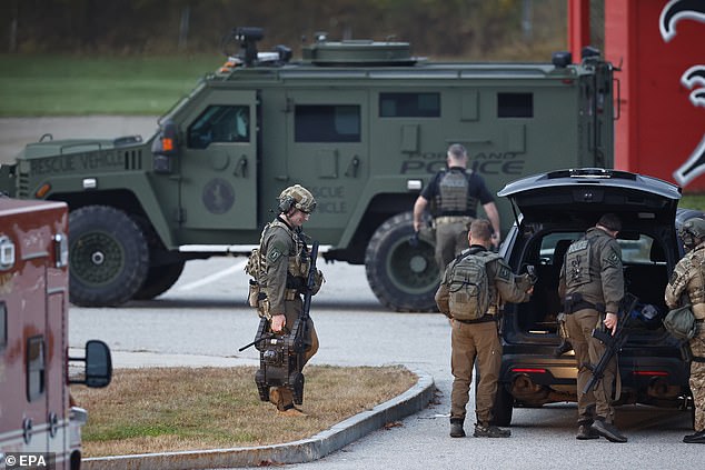 Tactical team members prepare to hit the road again to search for the suspect in a shooting in Lisbon