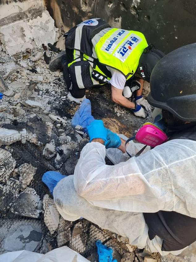 Forensic investigators recover bone fragments from the ruins of a burned-out house in Be'eri