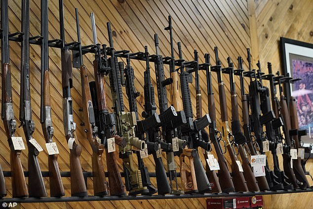 On July 18, 2022, several guns are on display at a store in Auburn, Maine