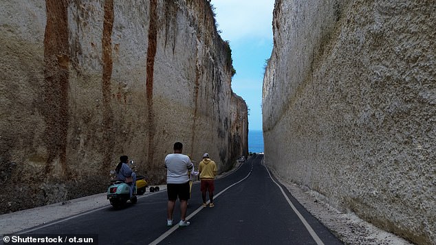 Despite mixed opinions, the road has become a major tourist attraction, with many travelers taking selfies and videos among the towering cliffs