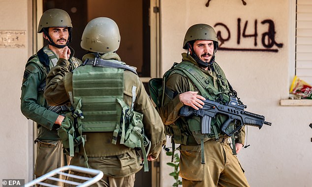 Israeli soldiers captured an area under attack by Palestinian militants in Kibbutz Holit