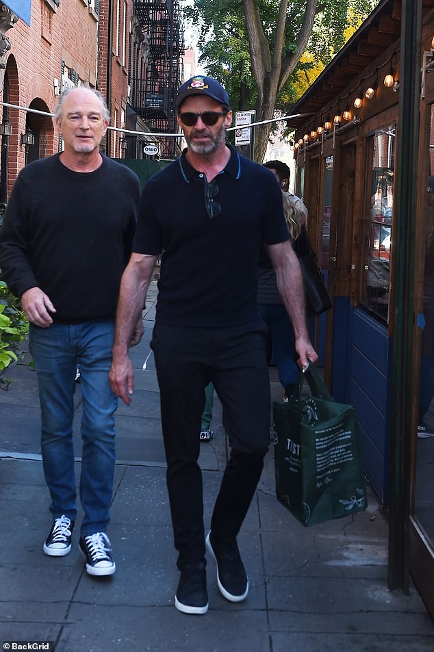 There he is: Hugh Jackman looked typically dashing as he stood up