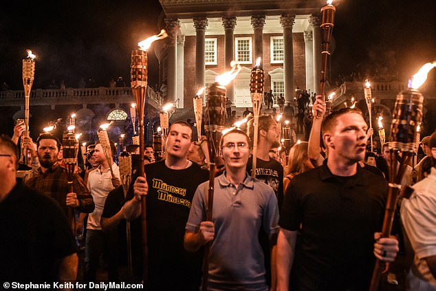 A group of white activists participate in a torch relay through the University of Virginia campus prior to the Unite the Right Rally in Charlottesville in August 2017