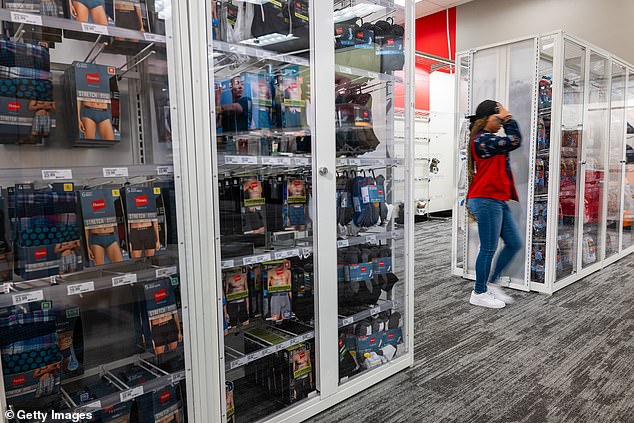 Products sit behind plexiglass in a Target store in Harlem.  This location was permanently closed last week