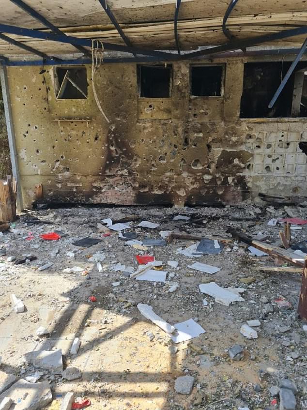 Debris can be seen all over the floor with holes in the wall and the ceiling beginning to collapse at a burned-out daycare center in Be'eri