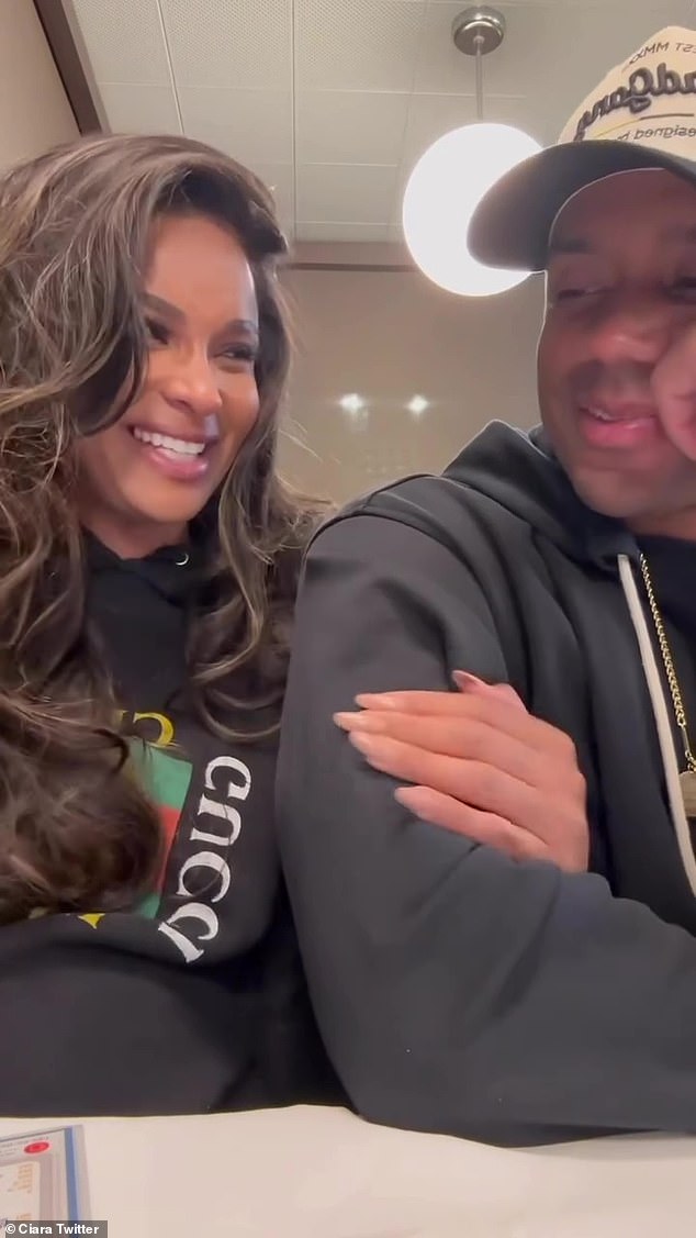 Happy: Ciara cuddled up to Russell in a clip where she says to her phone: 'Hey baby.  This is without a doubt the most epic thing you've ever done'