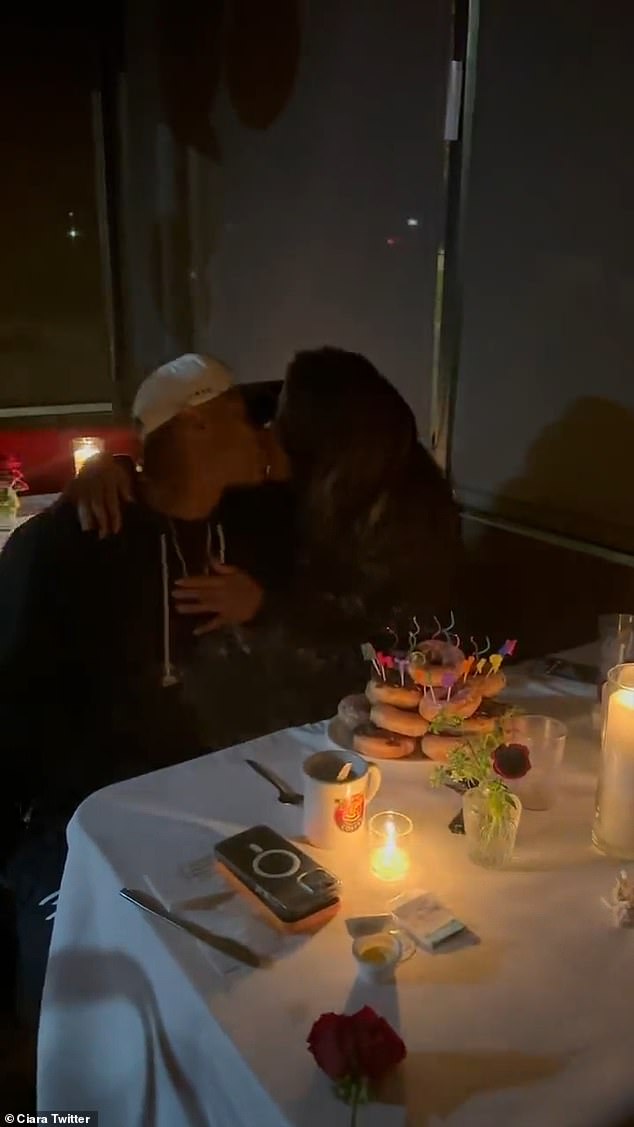 Lovebirds: She then kisses Russell before digging into her birthday treats