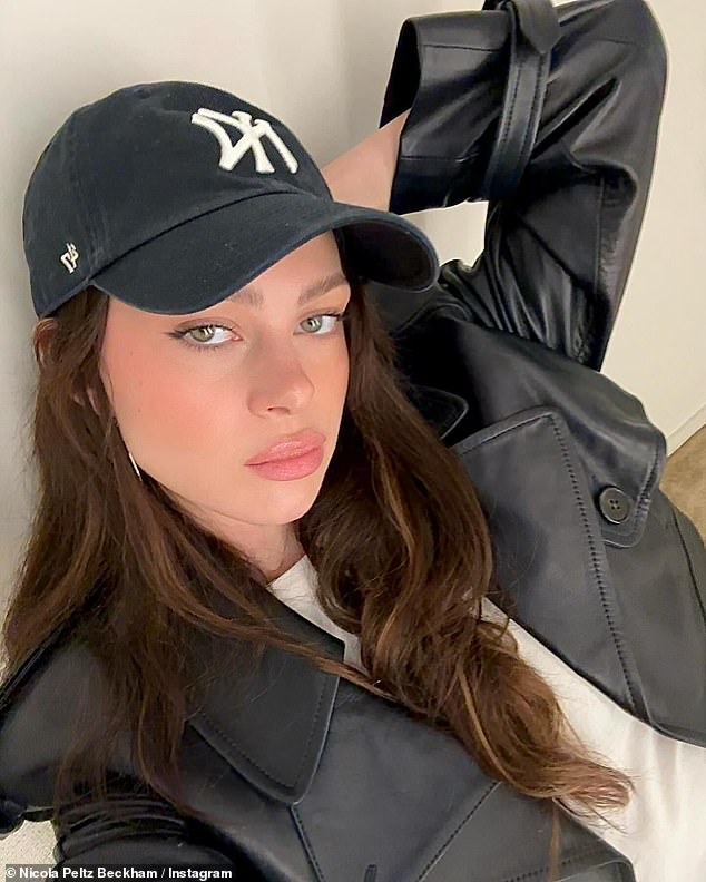 Gorgeous: Nicola showed off her flawless beauty in a black leather jacket and New York baseball cap