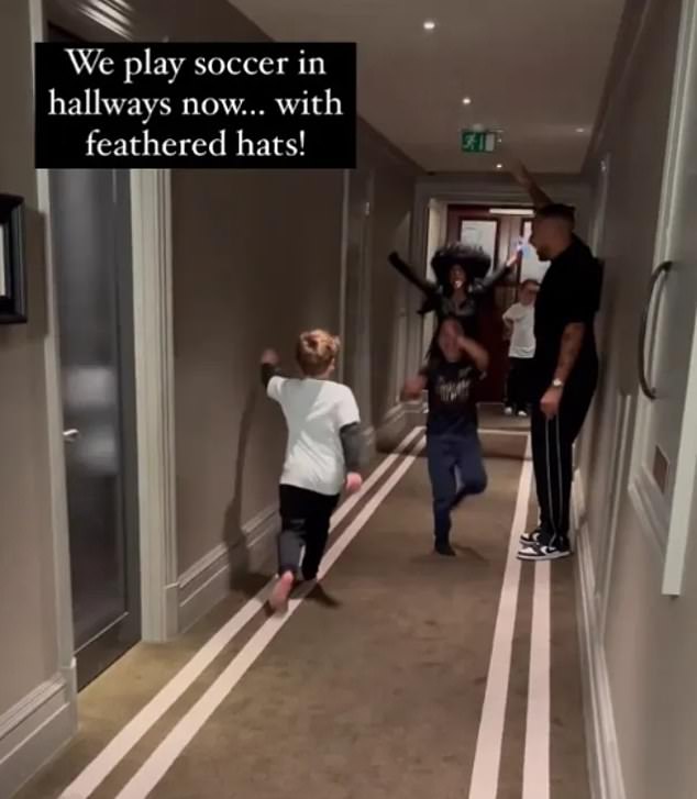 While in London, Kim's son Saint and his friends were seen playing football wearing 'feathered hats' with a man who appeared to be Ryan (far right in photo)