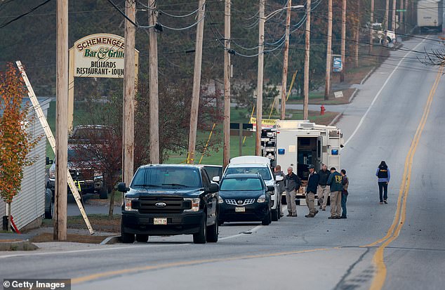 Law enforcement officers continue their investigation at the Schemengees Bar