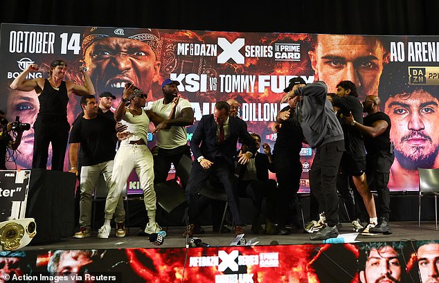 The YouTuber turned boxer was furious and jumped to his feet to take on Tommy's dad, before security flocked to the stage to prevent a mass brawl.