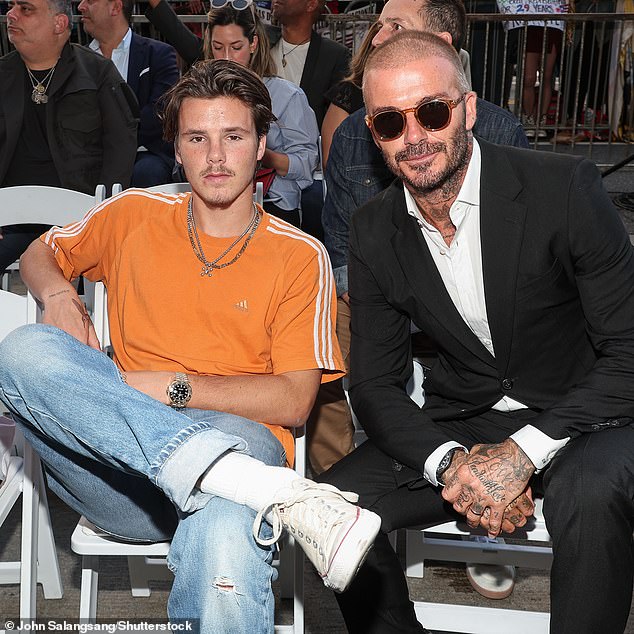 Family: Cruz, the newly single son of second-place David and Victoria Beckham, has been trying to carve out a career as a pop star for several years (pictured with David in September)