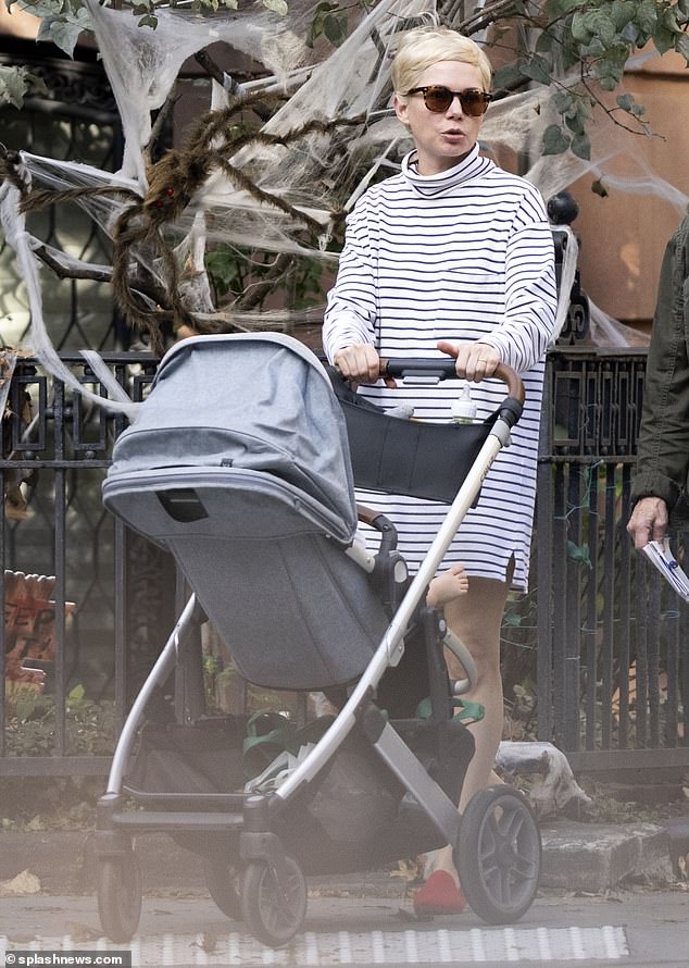 Chic style: Dressed in a striped mini dress and a pair of red flats, Michelle looked effortlessly chic