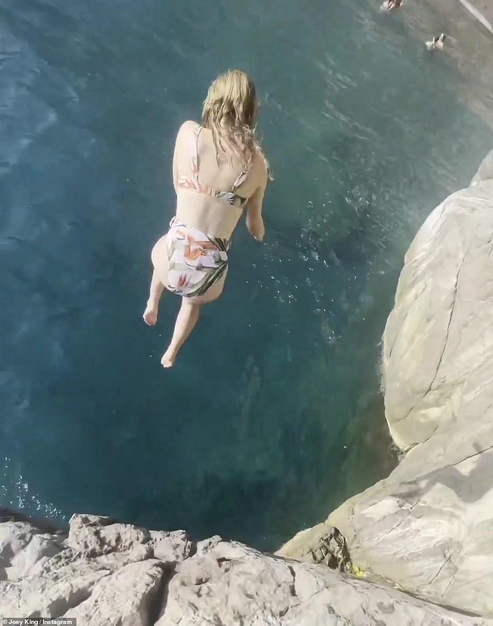 Brave girl: She was spotted jumping off the rocky coastline in Italy