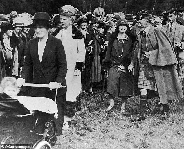 Queen Elizabeth II being pushed in her Silver Cross pram, followed by Queen Mary in 1927, the Queen Mother, King George V and her father, King George VI, through the grounds of Balmoral