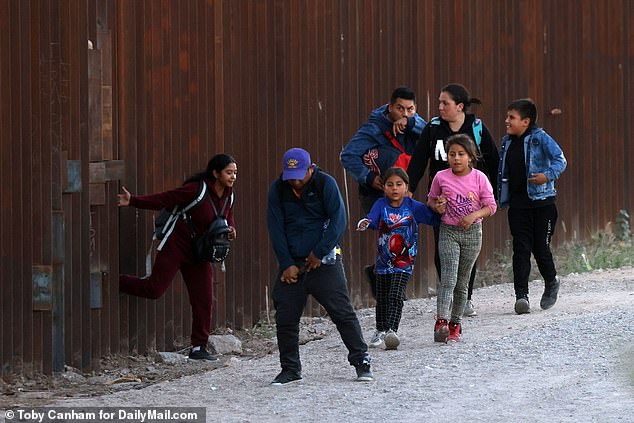 Once the coast is clear, the coyote pushes open one of the struts in the wall that has already been cut, allowing about eight migrants to pass through.