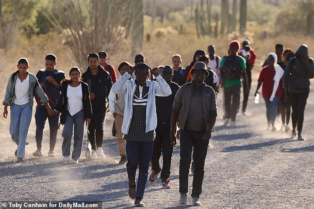 A little further from the border, a crowd of people walked towards a border guard post