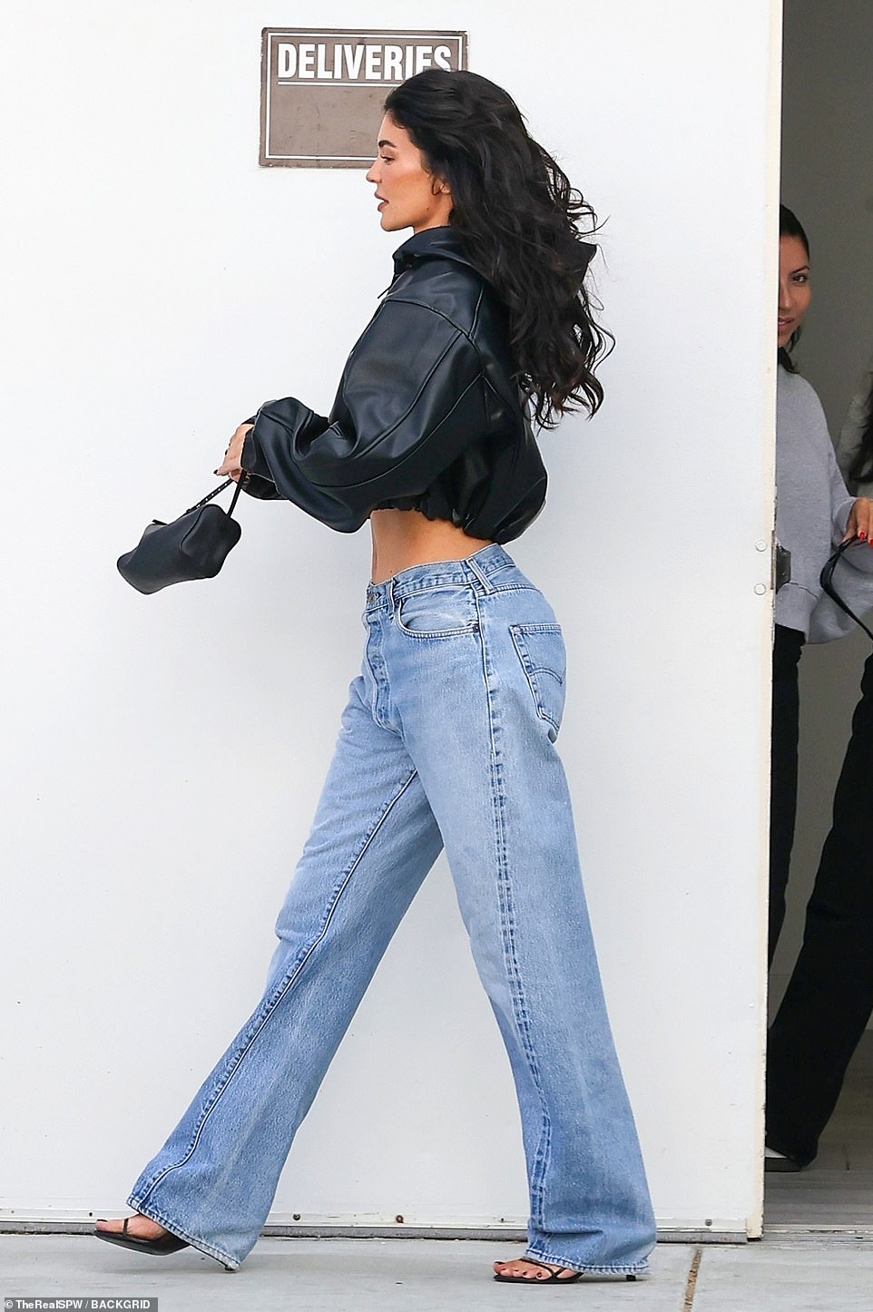 Stunner: The mother of two rocked a pair of faded low-rise denims and showed off her sculpted waist with confidence