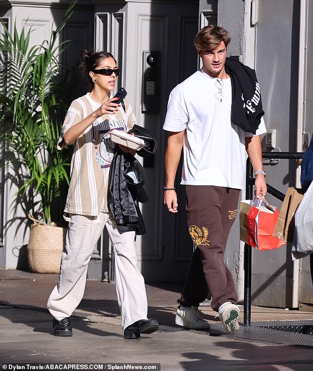 Hunky boyfriend: Riding behind was Scarlet's handsome boyfriend, Louis Masquelier-Page, a former University of Miami student