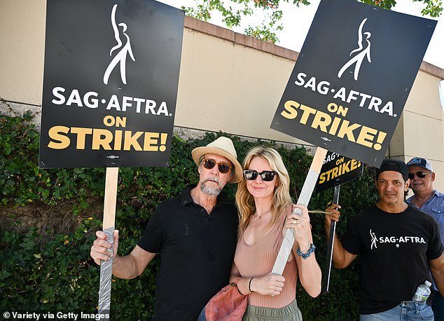 Celebrities on strike: Succession stars Alan Ruck and Justine Lupe pictured on the picket line in Los Angeles, California on July 18