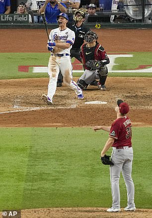 Corey Seager of Texas Rangers celebrates his two-run home run off Arizona Diamondbacks relief pitcher Paul Sewald during the ninth inning