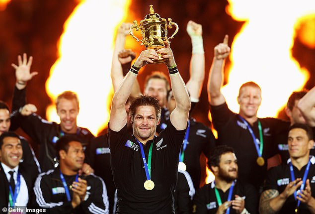 All Blacks captain Richie McCaw lifts the Webb Ellis Cup after a 24-year wait