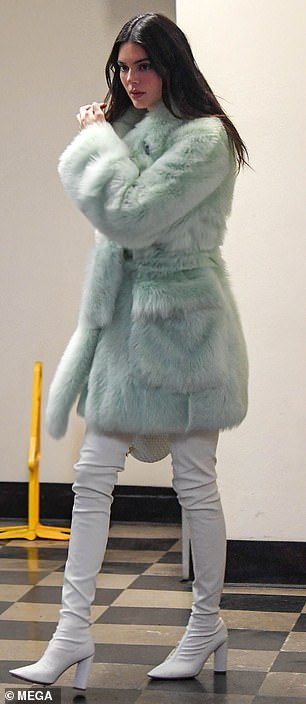 Glam: The KUWTK alum, 27, looked glam in a fluffy mint green coat with a matching handbag