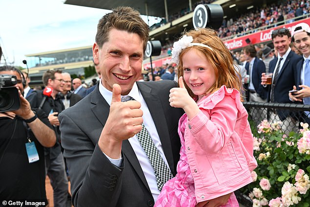 Trainer Mitchell Freedman poses with his daughter after Skybird won the 3 Point Motors Fillies Classic